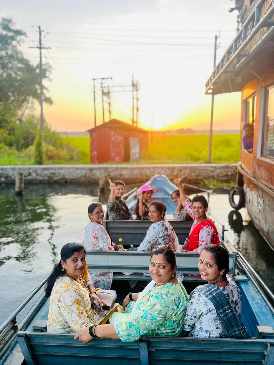 Passenger taking a portrait photo while riding through a calm evening canal