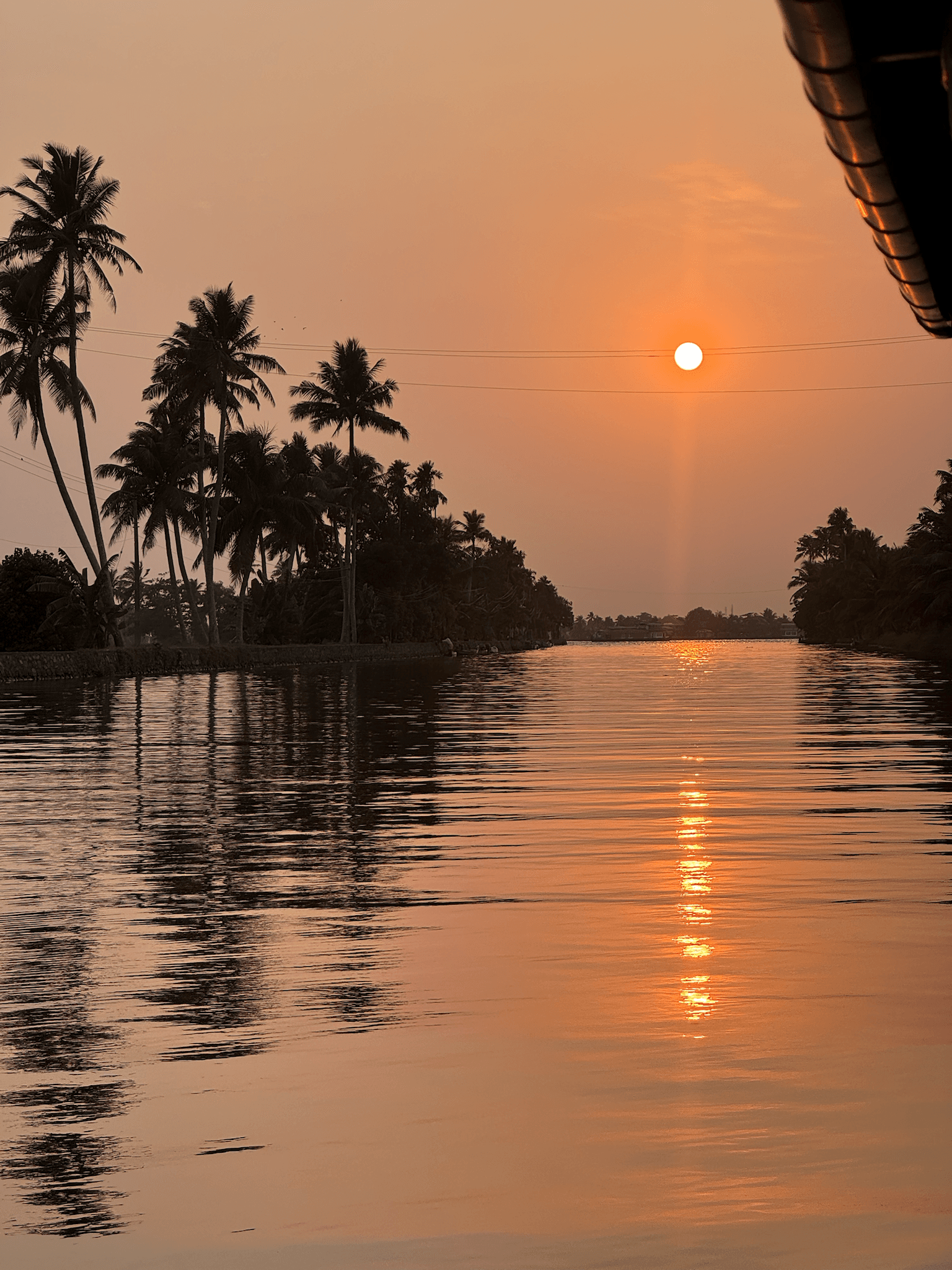 Couple enjoying golden-hour views on the Kerala backwaters